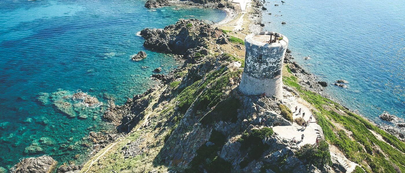 Genoese watchtower on a headland above turquoise Corsican water
