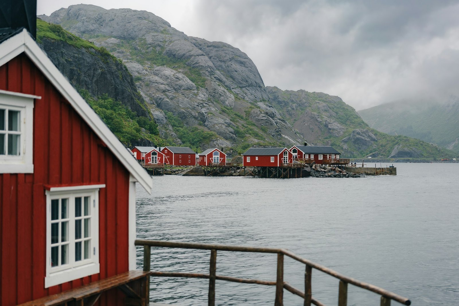 Traditional red fishing building by the water, Lofoten, coastal light