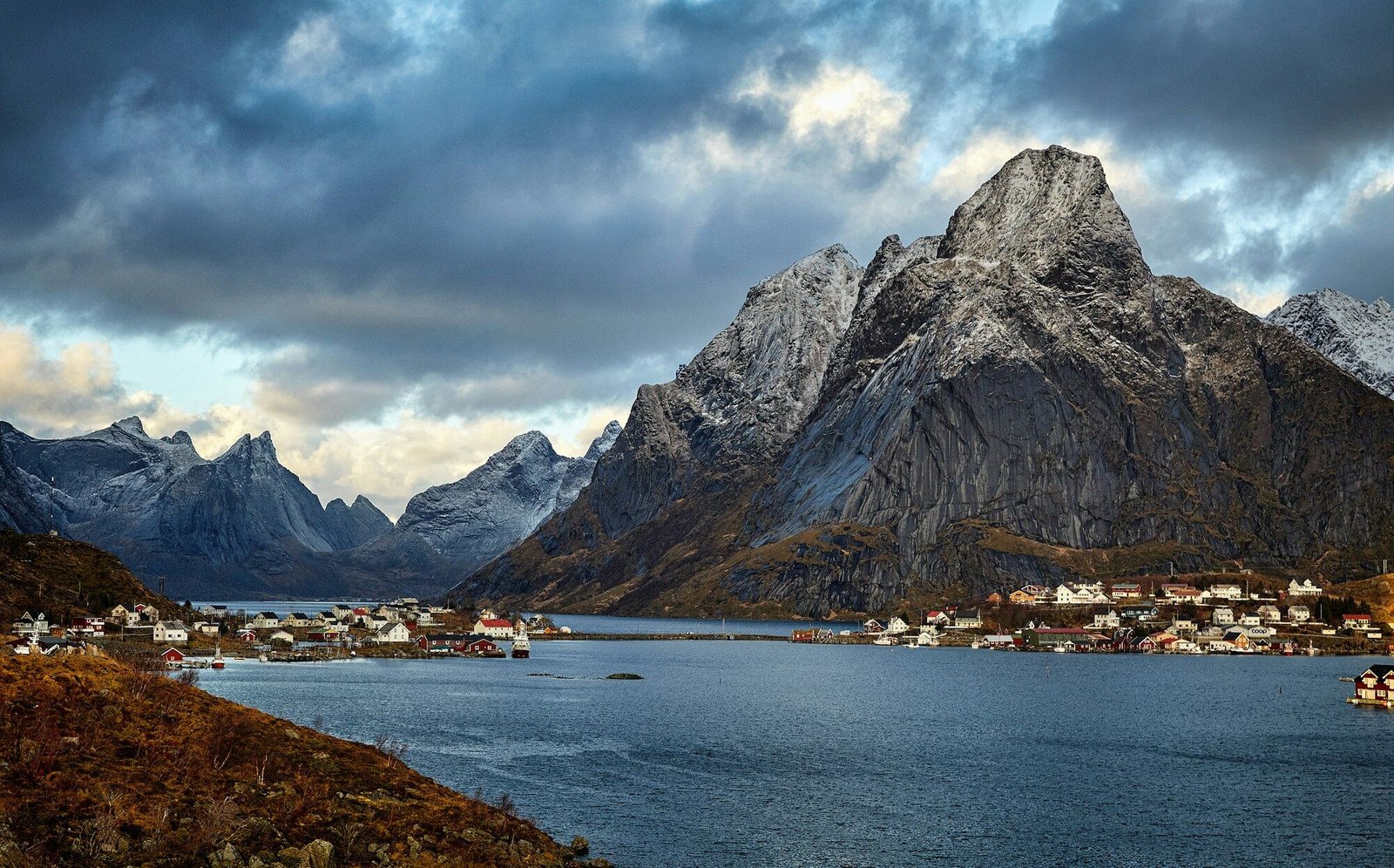 Lofoten mountains rising directly from the sea near Reine, dramatic light, no people