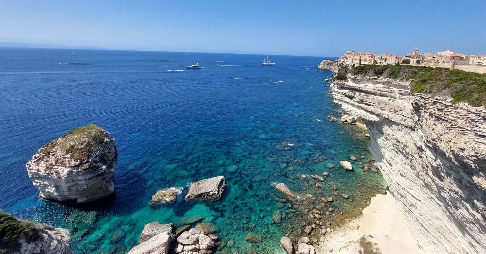The white limestone cliffs of Bonifacio above turquoise water, the old town perched along the clifftop